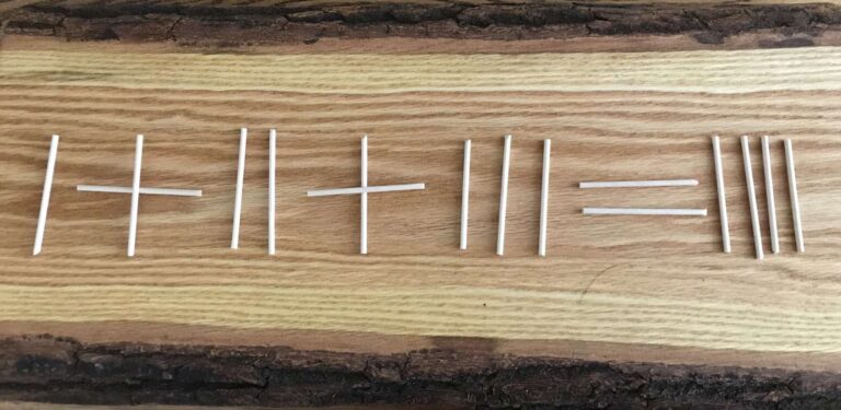 A stick puzzle laying on a wood table.